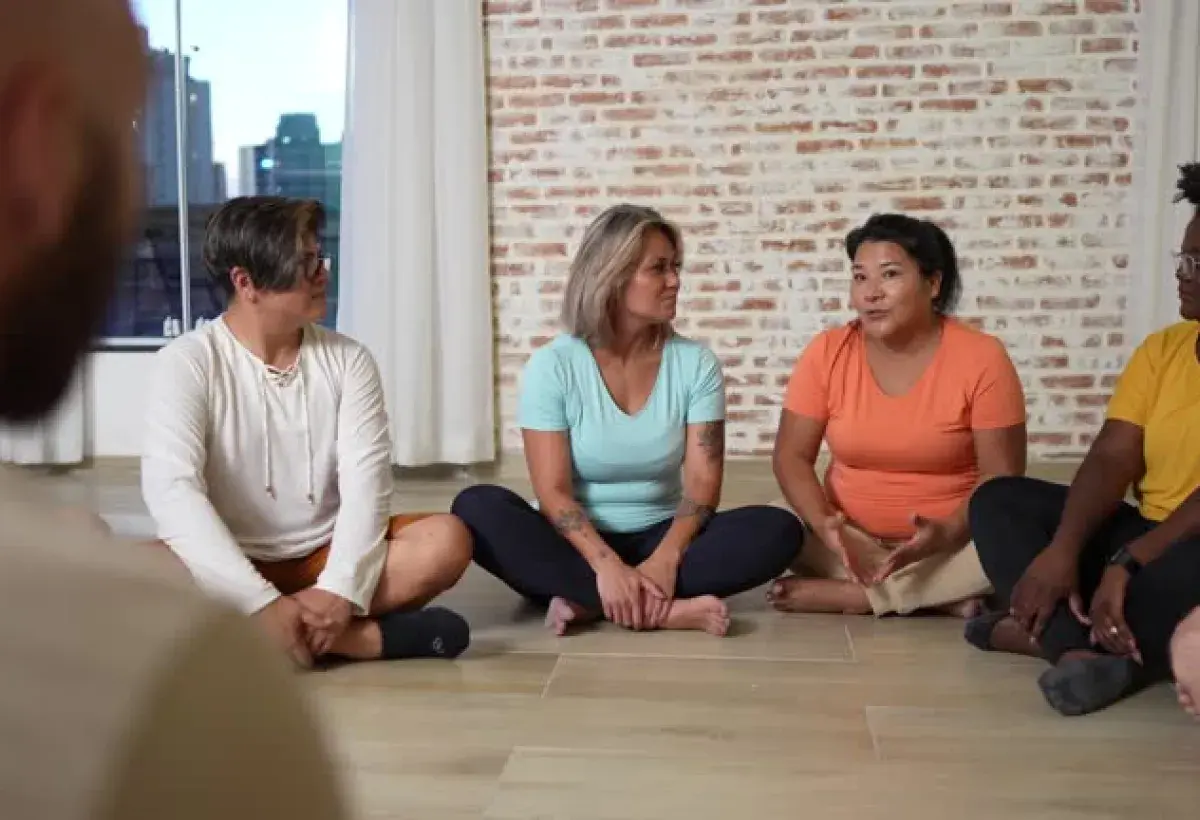 A group of Filipinas attending a wellness seminar, sharing experiences and supporting each other.