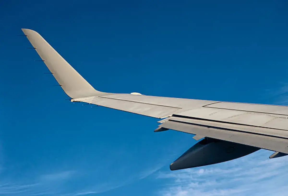 Airplane wing bending upward in flight