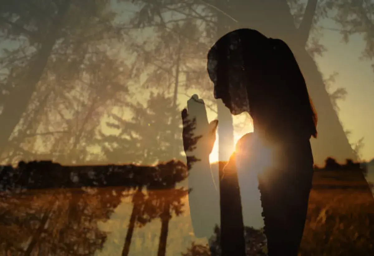 Person praying at sunrise representing intimacy with God