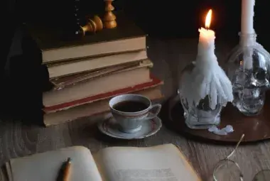 A candle burning beside a notebook during a quiet night of reflection