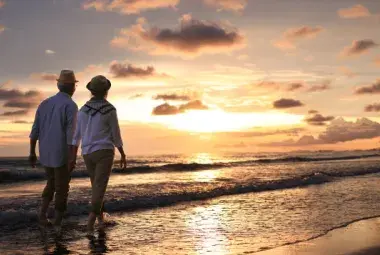 Retirees enjoying sunset on a Philippine beach.
