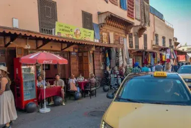 Taxi driving through Marrakech medina at dusk, setting the stage for a spontaneous musical adventure