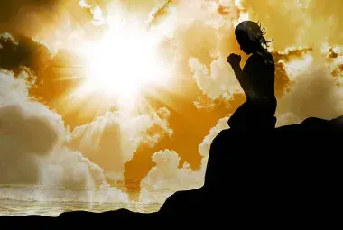 Person kneeling in sunlight representing God listening to human hearts